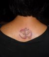 om tattoo on back of girl